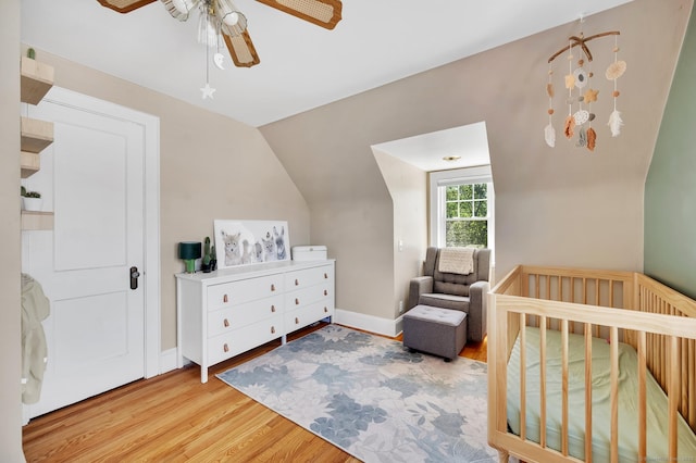 70 Mercer St, Stratford, CT 06614 - bedroom with wood finished floors, a crib, ceiling fan, lofted ceiling, and baseboards