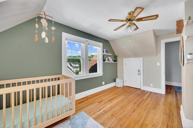 70 Mercer St, Stratford, CT 06614 - bedroom with lofted ceiling, wood finished floors, baseboards, ceiling fan, and a nursery area