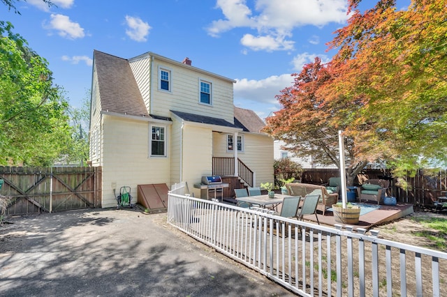 70 Mercer St, Stratford, CT 06614 - rear view of house with a fenced backyard, a patio area, an outdoor living space, and a chimney