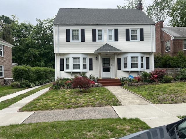 40 Bellevue Rd, New Haven, CT 06511 - colonial inspired home featuring a front lawn and a chimney