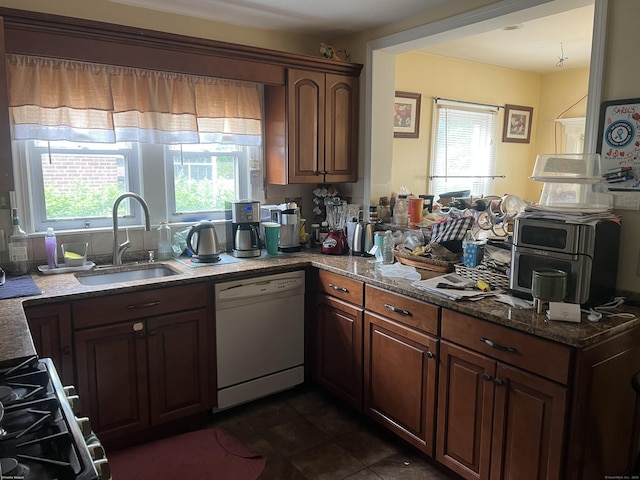 40 Bellevue Rd, New Haven, CT 06511 - kitchen with dishwasher, a sink, dark stone counters, a peninsula, and dark tile patterned floors