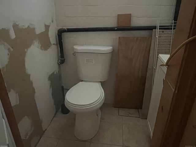 40 Bellevue Rd, New Haven, CT 06511 - bathroom with concrete block wall, toilet, and tile patterned floors