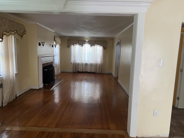 40 Bellevue Rd, New Haven, CT 06511 - unfurnished living room with a fireplace with raised hearth, crown molding, arched walkways, wood-type flooring, and baseboards