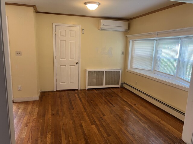 40 Bellevue Rd, New Haven, CT 06511 - unfurnished room featuring a wall mounted air conditioner, a baseboard heating unit, radiator heating unit, wood finished floors, and crown molding