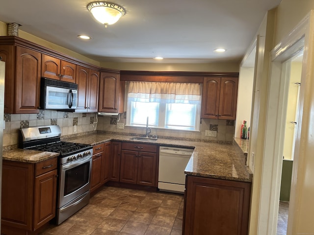 40 Bellevue Rd, New Haven, CT 06511 - kitchen with dishwasher, stainless steel range with gas stovetop, a sink, backsplash, and dark stone countertops