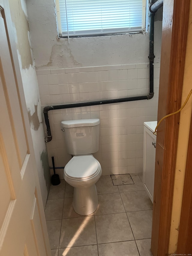 40 Bellevue Rd, New Haven, CT 06511 - bathroom featuring toilet, tile walls, tile patterned floors, vanity, and a wainscoted wall