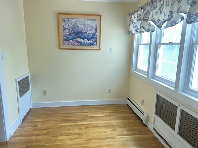 40 Bellevue Rd, New Haven, CT 06511 - unfurnished dining area featuring a baseboard radiator, light wood finished floors, and baseboards