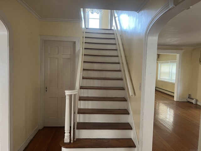 40 Bellevue Rd, New Haven, CT 06511 - staircase featuring arched walkways, wood finished floors, baseboard heating, plenty of natural light, and crown molding