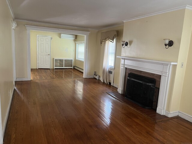 40 Bellevue Rd, New Haven, CT 06511 - unfurnished living room with a wall mounted AC, wood finished floors, a baseboard heating unit, a premium fireplace, and crown molding