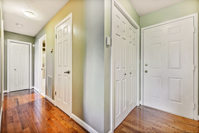 421 Tolland St Unit 312, East Hartford, CT 06108 - foyer featuring wood finished floors and a textured ceiling