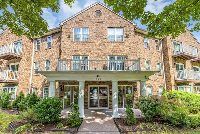 421 Tolland St Unit 312, East Hartford, CT 06108 - view of front facade featuring brick siding, a balcony, and a porch