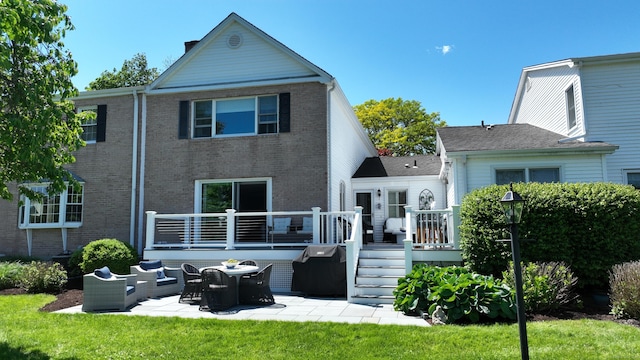 506 Jamestown Rd Unit 506, Stratford, CT 06614 - rear view of property featuring a patio, a deck, brick siding, a yard, and a chimney