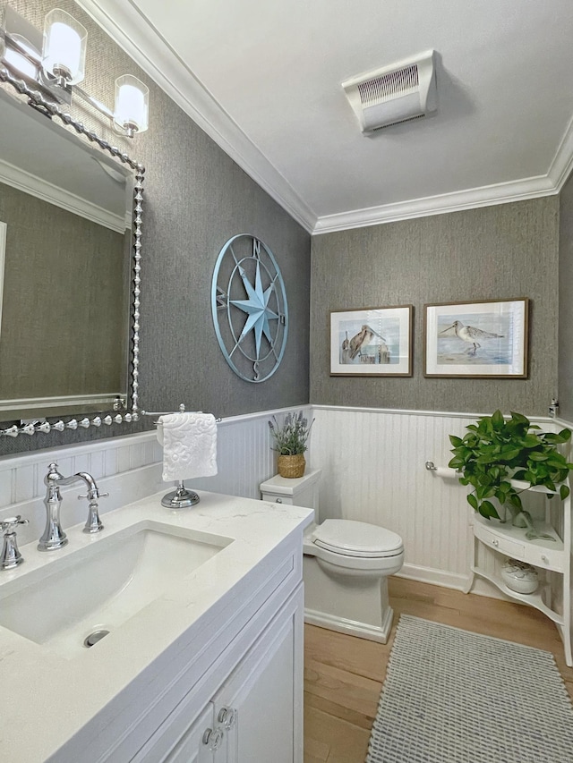 506 Jamestown Rd Unit 506, Stratford, CT 06614 - bathroom with wood finished floors, toilet, ornamental molding, vanity, and wainscoting