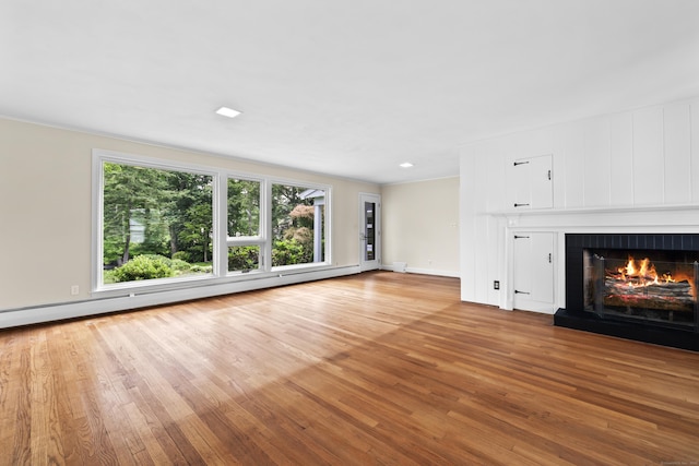 10 Wyndwood Rd, West Hartford, CT 06107 - unfurnished living room featuring light wood-style floors, a fireplace, and a baseboard heating unit