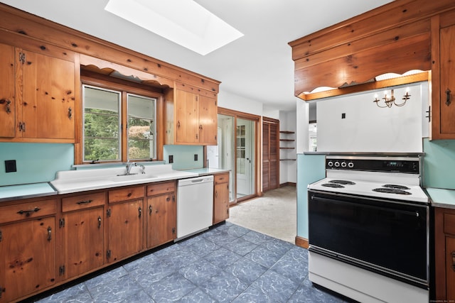 10 Wyndwood Rd, West Hartford, CT 06107 - kitchen featuring white appliances, a skylight, light countertops, brown cabinetry, and dark carpet