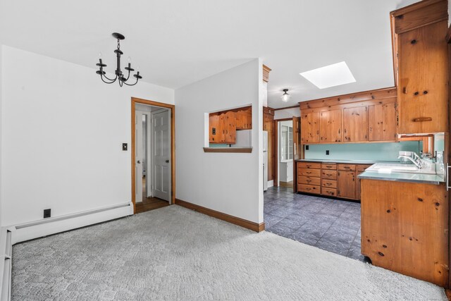 10 Wyndwood Rd, West Hartford, CT 06107 - kitchen with a skylight, brown cabinetry, light colored carpet, a chandelier, and light countertops