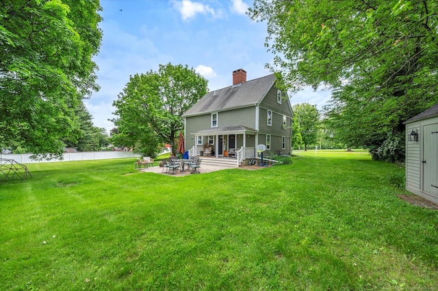 64 W St, Cromwell, CT 06416 - back of property with a chimney, a patio, and a shingled roof