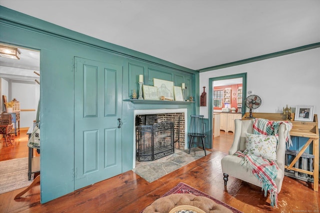 64 W St, Cromwell, CT 06416 - living area with a fireplace, wood finished floors, and ornamental molding