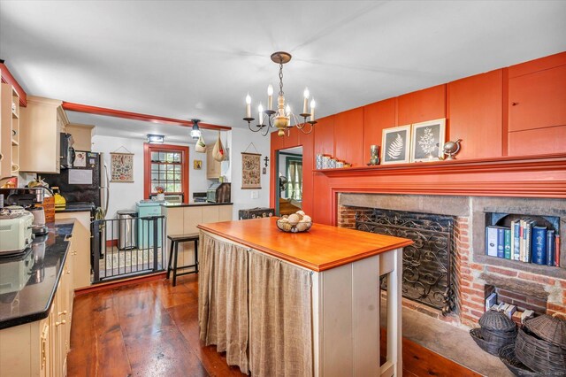 64 W St, Cromwell, CT 06416 - kitchen with dark wood-style flooring, a center island, a chandelier, and a fireplace