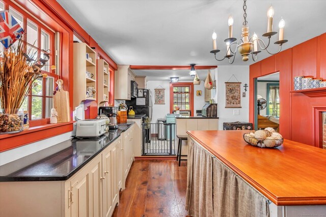 64 W St, Cromwell, CT 06416 - kitchen featuring dark countertops, dark wood-style floors, and a chandelier
