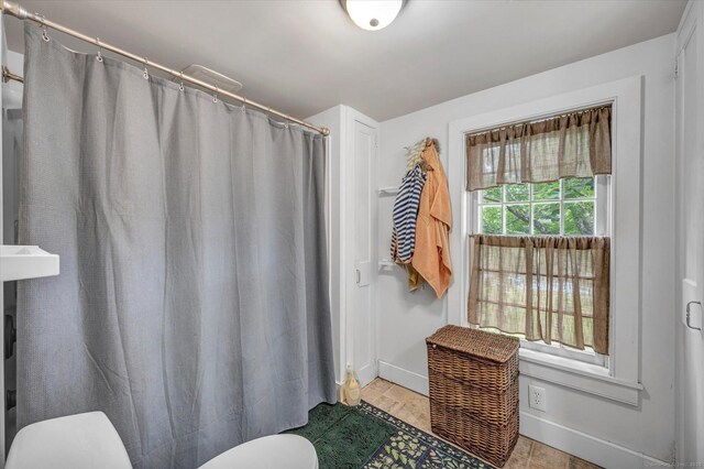 64 W St, Cromwell, CT 06416 - bathroom with toilet, baseboards, and a shower with shower curtain