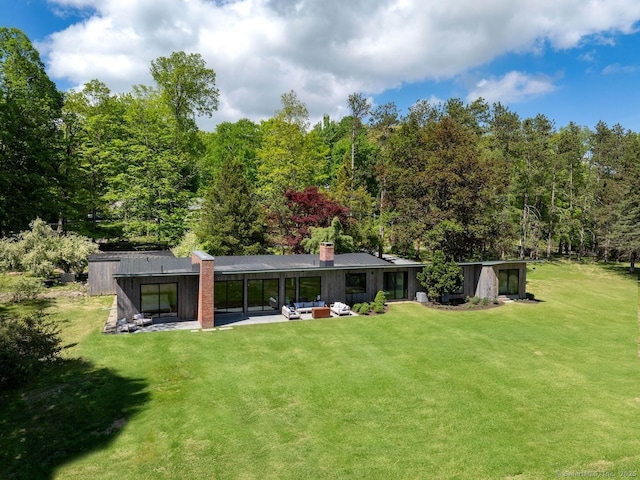 136 Belgo Rd, Salisbury, CT 06039 - back of house with a yard, a patio, a chimney, and an outdoor living space
