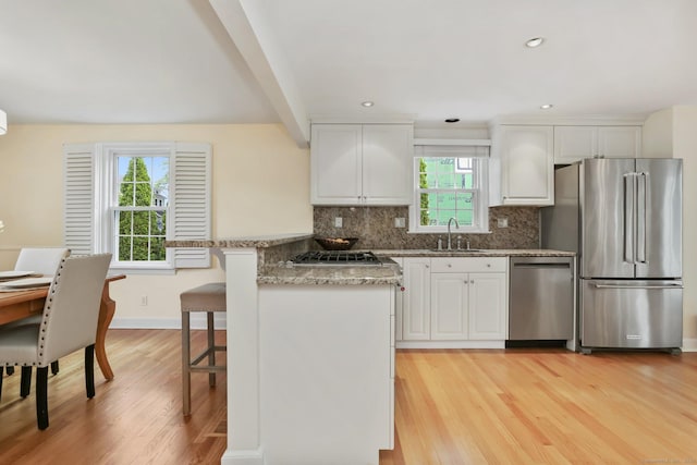 102 Pratt St, Fairfield, CT 06824 - kitchen featuring stainless steel appliances, light wood-style floors, white cabinetry, and recessed lighting