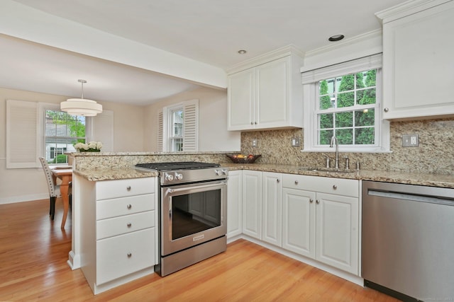 102 Pratt St, Fairfield, CT 06824 - kitchen featuring appliances with stainless steel finishes, a sink, a peninsula, plenty of natural light, and recessed lighting