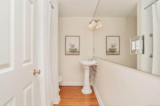 102 Pratt St, Fairfield, CT 06824 - full bathroom with toilet, wood finished floors, a shower with curtain, and baseboards