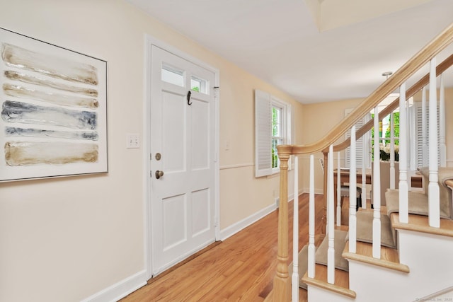 102 Pratt St, Fairfield, CT 06824 - foyer entrance with light wood finished floors, stairway, and baseboards