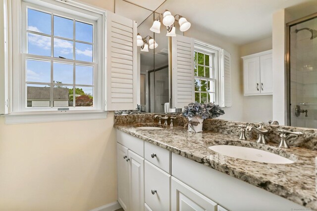 102 Pratt St, Fairfield, CT 06824 - bathroom featuring double vanity, a shower stall, and baseboards