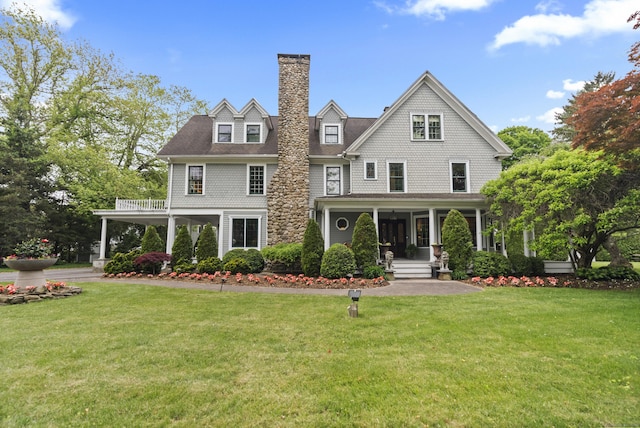 18 Ferry Rd, Old Lyme, CT 06371 - shingle-style home featuring covered porch, a front yard, and a chimney