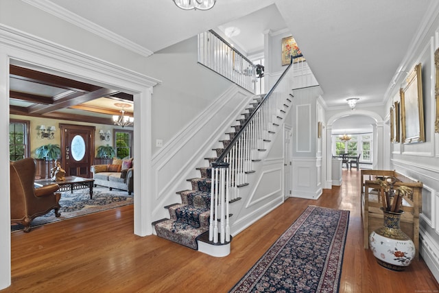 18 Ferry Rd, Old Lyme, CT 06371 - foyer entrance with a chandelier, stairs, wood finished floors, arched walkways, and ornamental molding