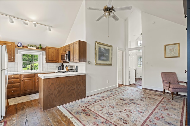 18 Ferry Rd, Old Lyme, CT 06371 - kitchen with stove, stainless steel microwave, track lighting, ceiling fan, and tile countertops