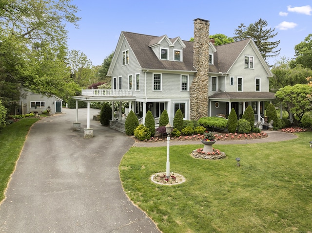 18 Ferry Rd, Old Lyme, CT 06371 - view of front of house featuring asphalt driveway, a chimney, a front yard, a porch, and a shingled roof