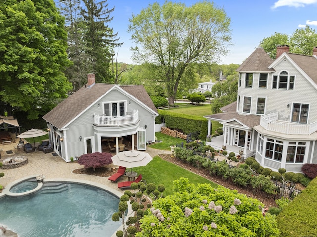 18 Ferry Rd, Old Lyme, CT 06371 - back of house with a balcony, roof with shingles, a chimney, and a patio