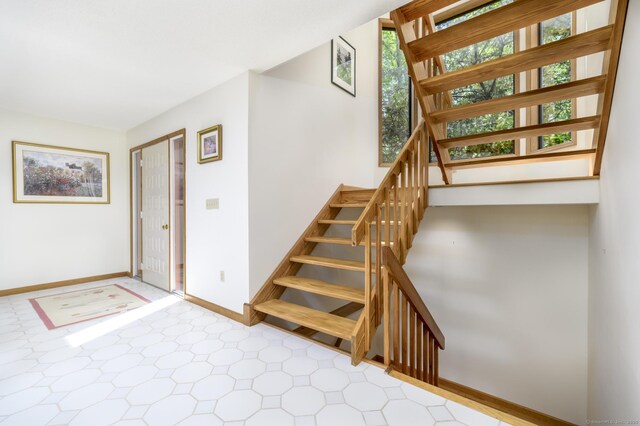 17 Walker Ln, Weston, CT 06883 - stairway with healthy amount of natural light, baseboards, and tile patterned floors