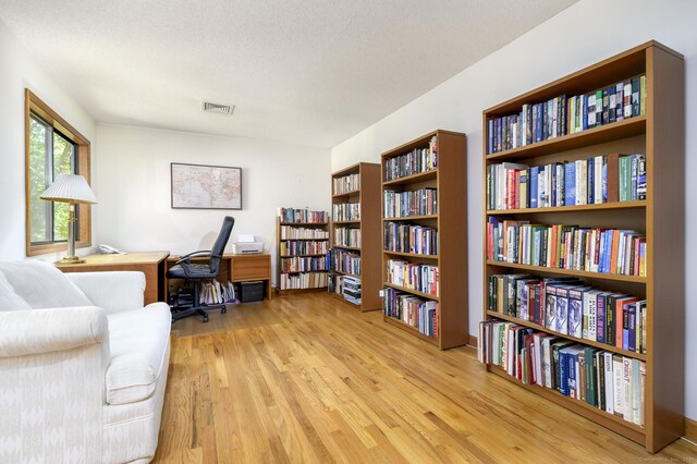 17 Walker Ln, Weston, CT 06883 - office featuring bookshelves, light wood-type flooring, and a textured ceiling