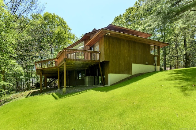 17 Walker Ln, Weston, CT 06883 - back of property featuring a deck, a lawn, and central AC