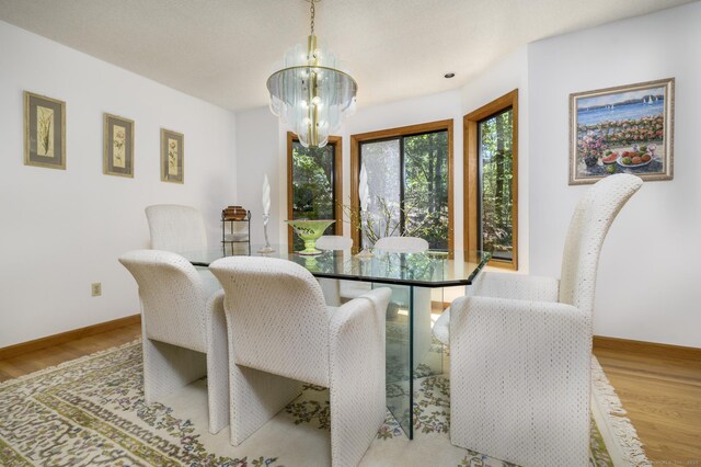 17 Walker Ln, Weston, CT 06883 - dining room featuring a chandelier, wood finished floors, and baseboards