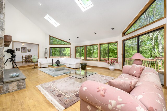 17 Walker Ln, Weston, CT 06883 - living area with high vaulted ceiling, a skylight, plenty of natural light, and wood finished floors