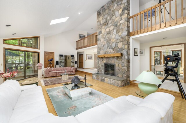 17 Walker Ln, Weston, CT 06883 - living room with high vaulted ceiling, wood finished floors, plenty of natural light, a skylight, and a stone fireplace