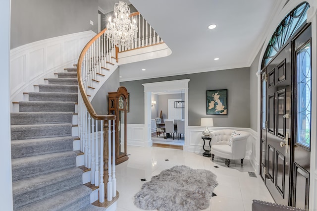368 Nod Hill Rd, Wilton, CT 06897 - tiled foyer entrance with stairway, a decorative wall, a chandelier, crown molding, and recessed lighting