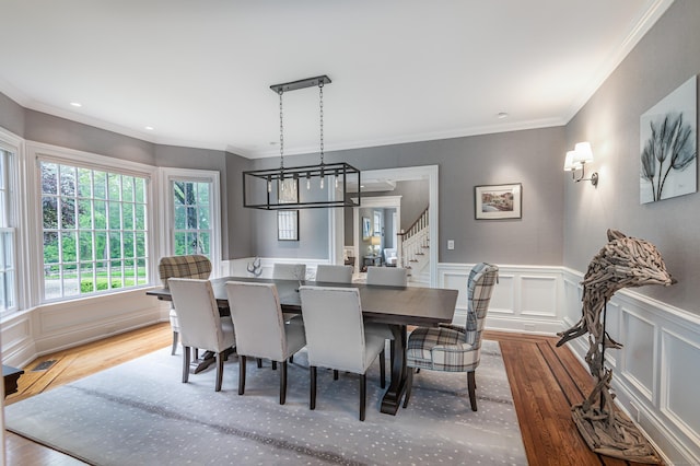 368 Nod Hill Rd, Wilton, CT 06897 - dining area featuring wood finished floors, stairs, a decorative wall, a chandelier, and ornamental molding