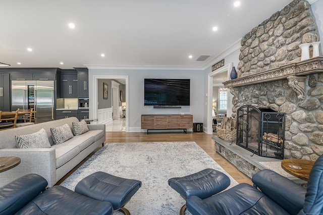 368 Nod Hill Rd, Wilton, CT 06897 - living room featuring crown molding, light wood-style floors, a stone fireplace, recessed lighting, and baseboards