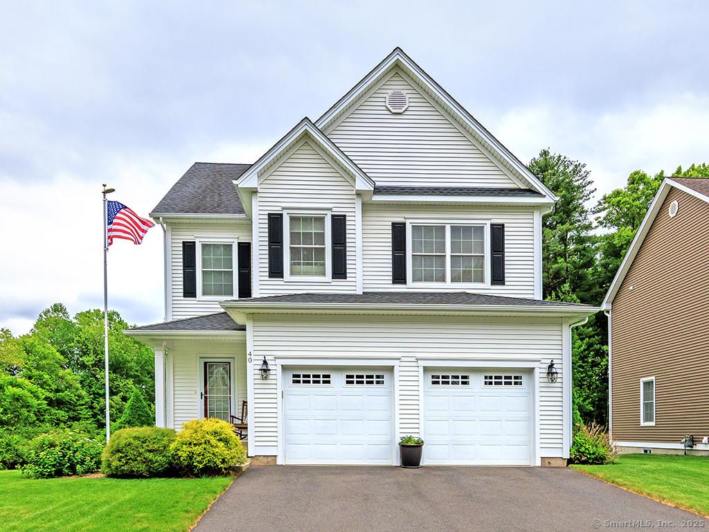 40 Great Plain Dr Unit 40, Plainville, CT 06062 - traditional home featuring asphalt driveway, an attached garage, and a front lawn
