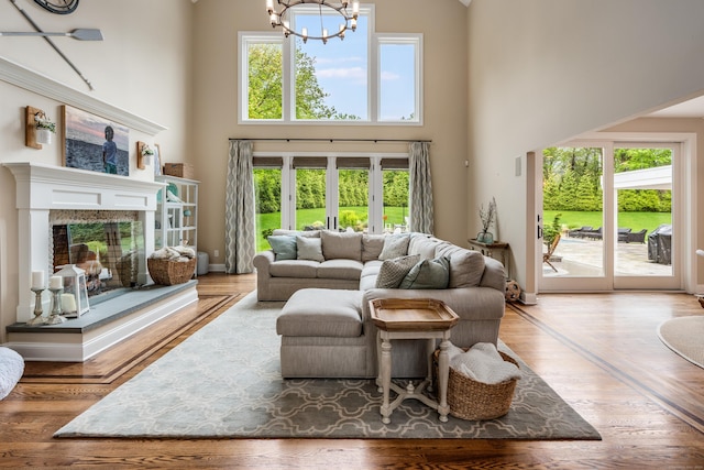 15A Shore Rd, Waterford, CT 06385 - living area featuring a towering ceiling, a chandelier, a premium fireplace, and french doors