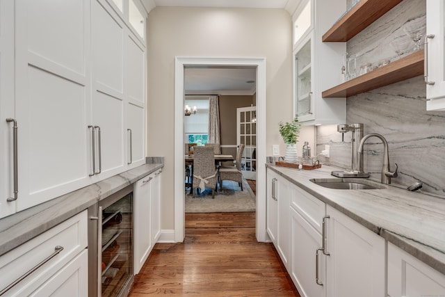 15A Shore Rd, Waterford, CT 06385 - indoor wet bar featuring beverage cooler, wood finished floors, ornamental molding, and a chandelier