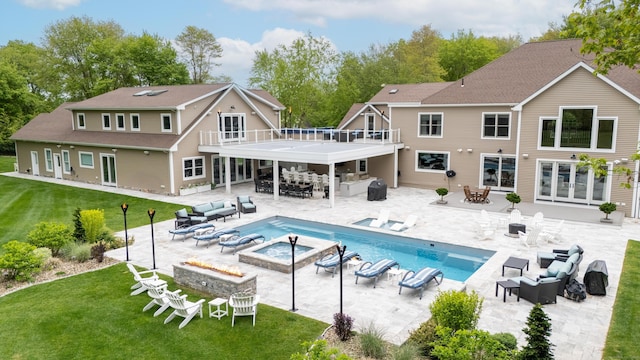 15A Shore Rd, Waterford, CT 06385 - rear view of house with an outdoor living space with a fire pit, outdoor dining space, a balcony, a yard, and an outdoor pool
