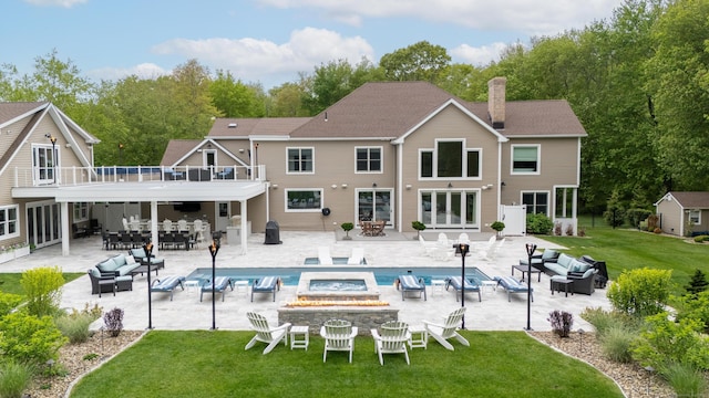 15A Shore Rd, Waterford, CT 06385 - back of property with an outdoor living space with a fire pit, a lawn, outdoor dining space, and an outdoor pool